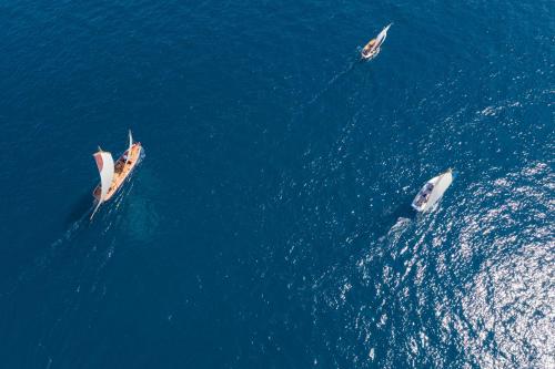 a group of three boats in the water at Villa Marica Tiny House in Krk city centre in Krk