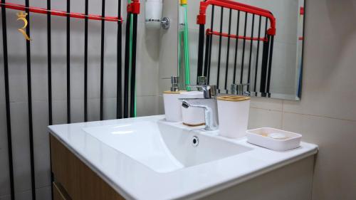 W łazience znajduje się biała umywalka i lustro. w obiekcie City Chic: Elegant 1BR Apartment w Abu Zabi