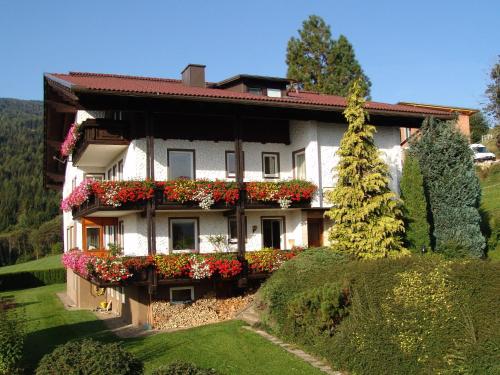 a house with flower boxes on the side of it at Cozy Apartment in Afritz am See near Gerlitzen Ski Area in Afritz