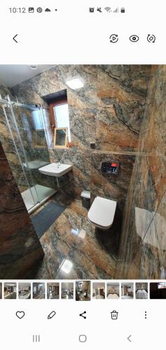 a bathroom with a sink and a toilet in a room at Holiday House in Krynica Morska