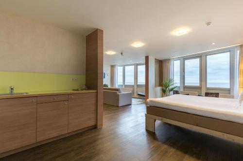 ノールトウェイク・アーン・ゼーにあるHotel de Baak Seasideのベッドルーム(大型ベッド1台付)、バスルームが備わります。