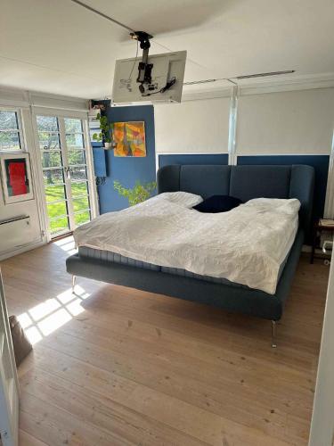 a bedroom with a large bed in a room at Lovely Bright Summer House Close To Hornbæk, in Hornbæk