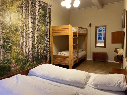um quarto com 2 beliches e uma pintura de árvores em Country Idyll With Wilderness Bath And Sauna, em Haderslev