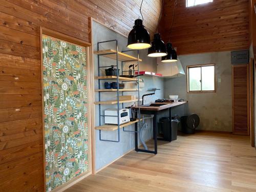 a kitchen with wooden walls and a wall with a shelf at Cottage Coliberty - Vacation STAY 60563v in Anan