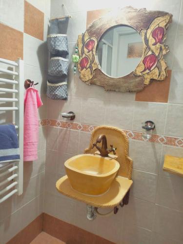 a bathroom with a sink and a mirror at Triantafillies Traditional Hotel in Portariá