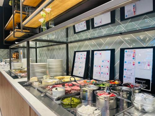 a buffet line with food on a counter in a restaurant at Hotel am Kloster in Werne an der Lippe