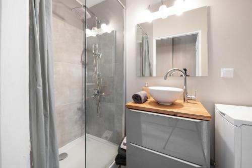 a bathroom with a sink and a shower at Koliber by 3City Rentals in Gdynia