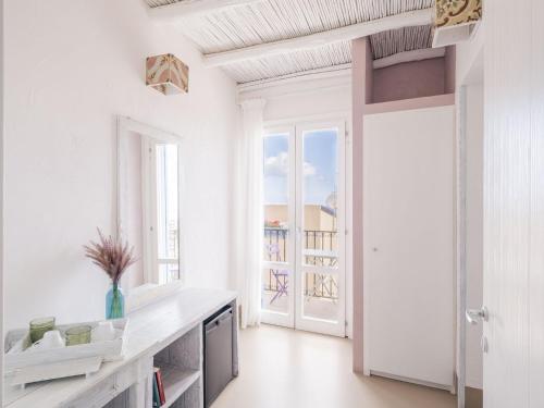 a kitchen with white walls and a large window at Tannur B&B in Castellammare del Golfo
