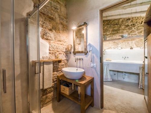 a bathroom with a sink and a toilet and a shower at Masseria de Li Travaj - in Salento - RivedelSalento in Patù
