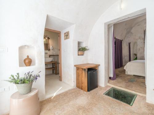 a white room with a table and a bedroom at Masseria de Li Travaj - in Salento - RivedelSalento in Patù