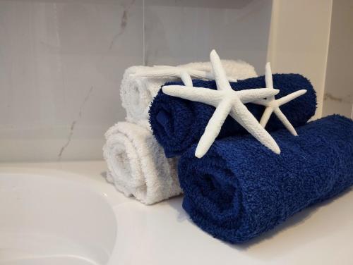 two towels and two starfish on a bathroom counter at Blue Sea Apartment in Torvaianica