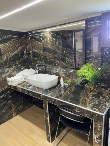 a bathroom with a sink on a marble counter at Κτήμα Mairy΄s House in Flogita