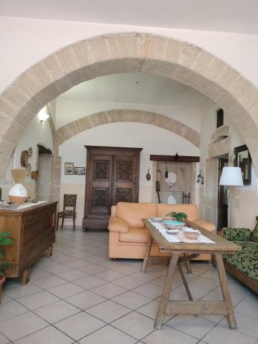 a living room with a couch and a table at La Casa Rossa in Riola Sardo