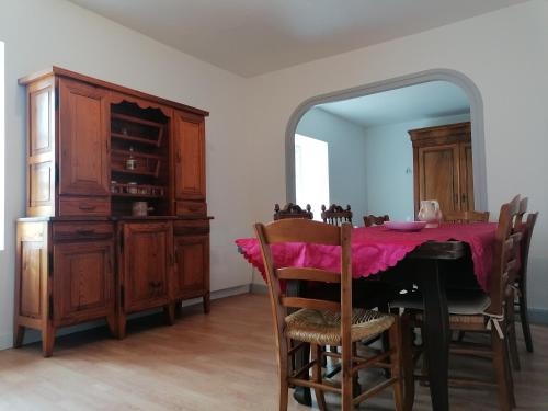 a dining room with a table and a mirror at Gite Bains jolivet in Bains