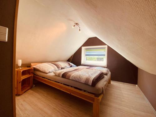 a bedroom with a bed and a window at Alte Schmiede in Melzow