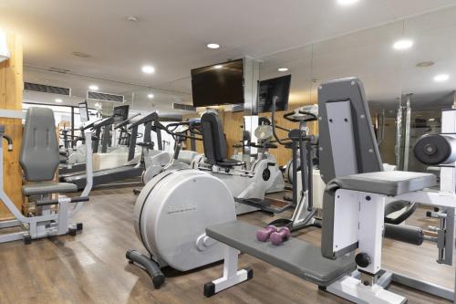 a gym with several treadmills and exercise equipment at Best Western Premier CMC Girona in Girona