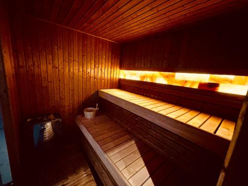 a wooden sauna with a trash can in it at Vera HOTEL-VILLA in Pristina