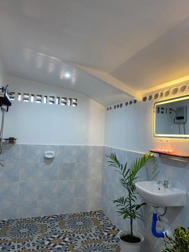 a bathroom with a sink and a mirror at Residencia Gemma in Siquijor