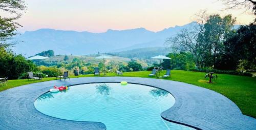 a swimming pool with a view of a mountain at Coach House Hotel & Spa Tzaneen in Tzaneen
