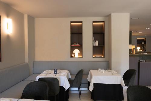 a dining room with two tables and chairs at Best Western Premier CMC Girona in Girona