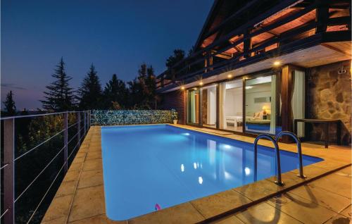 a swimming pool in front of a house at night at Beautiful Home In Samobor With Kitchen in Samobor