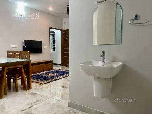 a bathroom with a sink and a mirror at 88 Homes edappally in Cochin