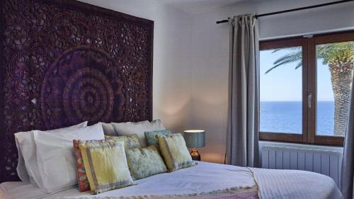 a bedroom with a bed and a window with the ocean at Santa Eulalia - 4739 Ibiza in Cala Llonga