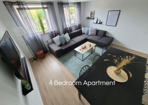 a living room with a couch and a table at Cozy Apartment in Bedburg-Hau in Bedburg Hau