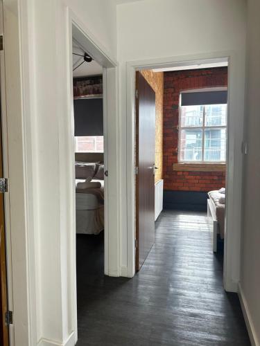 a hallway with an open door to a bedroom at Industrial Escape -Kelham Island in Sheffield