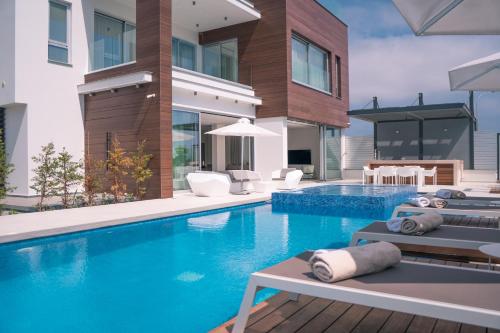 a swimming pool in a house with a house at Vivo Mare Beachfront Villas - Vista in Ayia Napa
