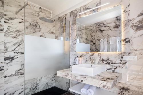 uma casa de banho com um lavatório e um espelho em Hotel BlauMar Llafranc em Llafranc