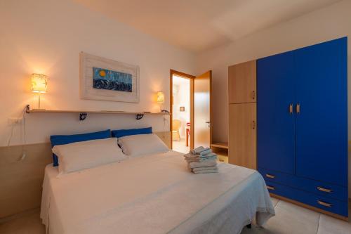 a bedroom with a large bed with a blue cabinet at Casa Bellaria by RivedelSalento vista mare Castro in Castro di Lecce