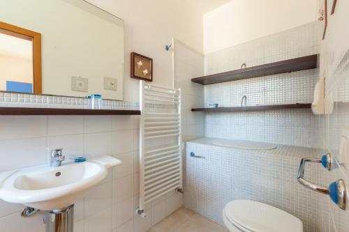 a white bathroom with a sink and a toilet at Casa Bellaria by RivedelSalento vista mare Castro in Castro di Lecce