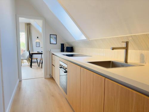 a kitchen with a sink and a counter top at Pension Tüxen in Hasselberg