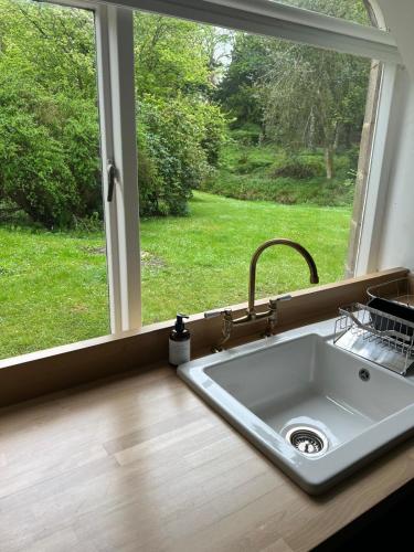 a sink in a kitchen next to a window at East Lodge - Chillingham Castle in Alnwick