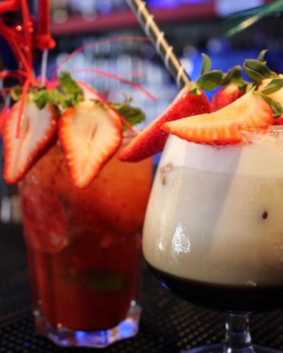 a strawberry margarita and a drink on a table at Vegas Residence - Adults Only in Albufeira