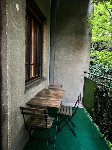 a wooden table and two chairs sitting on a porch at NewBerry Apartment with Balcony in Budapest