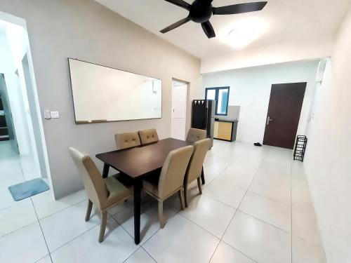 a dining room with a table and chairs and a ceiling fan at Meritus Residensi Penang in Perai