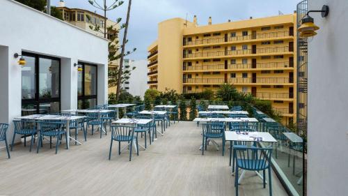 a row of tables and chairs on a patio at Medplaya Hotel Bali in Benalmádena