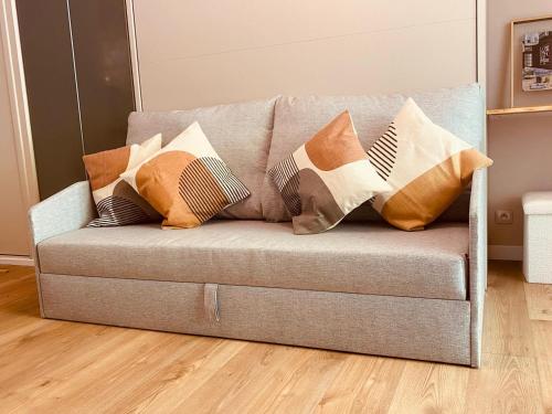 a couch with pillows on it in a living room at Bandol A Bandol cha cha cha - Appartement in Bandol