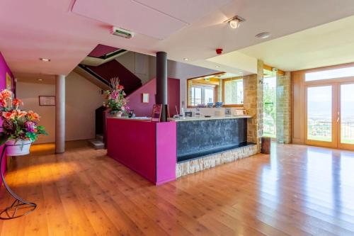 a kitchen with a purple counter in a room at Hotel Alda Triskel in Sos del Rey Católico