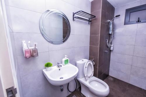 a bathroom with a toilet and a sink and a mirror at Meritus Residensi Penang in Perai