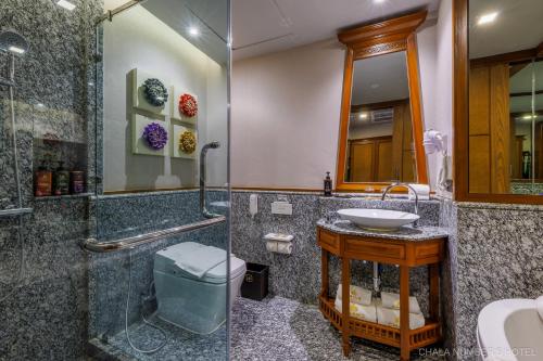 a bathroom with a glass shower and a sink at Chala Number6 in Chiang Mai