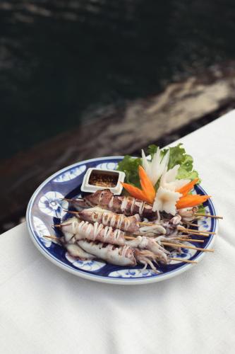a plate of food with fish and vegetables on a table at Khla Lodge in Kampot