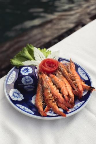 a blue and white plate of food on a table at Khla Lodge in Kampot