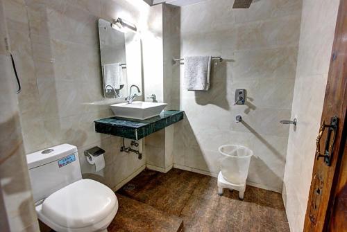 a bathroom with a white toilet and a sink at Hotel Highway Inn Manali - Luxury Stay - Excellent Service - Parking Facilities in Manāli