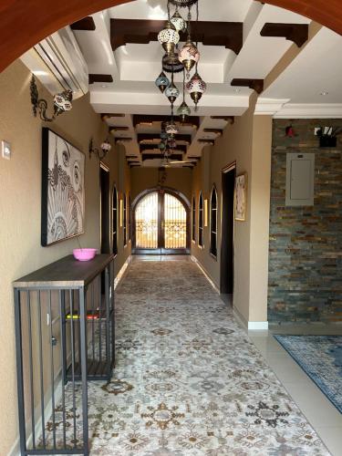 a hallway in a building with a ceiling and a hallway with a hallwayngthngth at Valley Guest Home in Nizwa