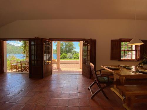a living room with a table and a view of the water at Casa do Lago in Tomar