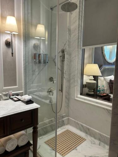 a bathroom with a shower with a glass door at Welcomhotel by ITC Hotels, The Savoy, Mussoorie in Mussoorie