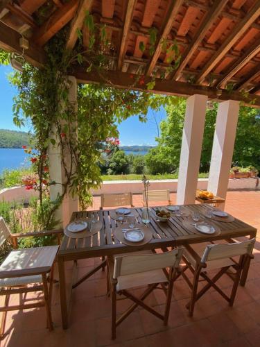 a wooden table and chairs on a patio at Casa do Lago in Tomar